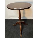 Antique flip top wine table, the circular top raised on a turned [70cm high, 50cm diameter]