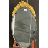 Oval mirror surmounted with gilt moulded foliage [75x40cm]