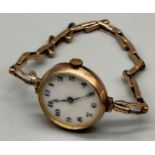 Ladies 9ct gold wrist watch, white enamel face, 9ct gold elasticated band. [18.14grams]