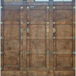 19th century walnut wardrobe, moulded extensions above a frieze, leading to a trio of panel doors