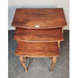 Antique mahogany nest of tables, the bow front rectangular top, raised on fluted legs ending in