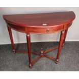 Antique style mahogany demi-lune table, the D-shaped surface above a frieze drawer, raised on turned
