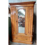 Antique wardrobe, the shaped moulded cornice above a central mirrored door leading to interior