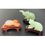 Three various Chinese Jade hand carved figures with wooden stands. Two cats and elephant. [Cat 6cm
