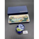 A Moorcroft ornate pen tray together with a small Moorcroft floral design lidded dish. [Will not