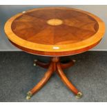 Antique style mahogany table, the circular surface with banding and inlaid shell design, raised on a