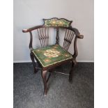 Antique mahogany corner chair, the shaped and cushioned back support above open scroll arms and