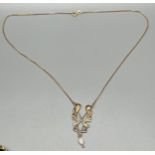 9ct yellow gold ornate pendant set with a single pearl attached with a 9ct yellow gold necklace. [