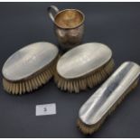 Three silver marked hand brushes together with a London silver Christening mug. [All engraved] [Will