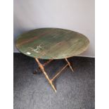 Victorian folding coaching table, the top opening to an oval surface, raised on folding X-frame legs