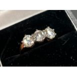 18ct yellow gold three stone diamond ring set in 18ct white gold, the three diamonds are round