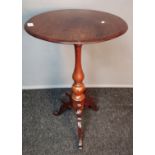 Antique mahogany side table, the circular top, raised on a turned column and three carved cabriole