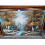 Oil painting depicting river and forest scene signed Jin P fitted in a gilt frame.