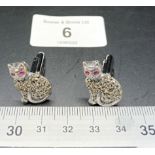 A pair of silver and marcastie cat cufflinks with ruby eyes