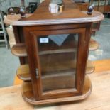 Ornate mahogany wall cabinet .