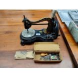 An antique hand Cranked sewing machine by Jones with original leaflet and accessories .