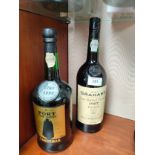 Bottle of W&J Grahams 1987 port together with 1990 bottle of Sandeman tawny port .