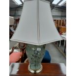 Large interior table lamp depicting birds fitted with a shade.