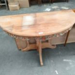 Ornate carved heavy wood half moon table .