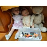 Selection of antique dolls , antique teddy bear together with box of vintage farm animals .