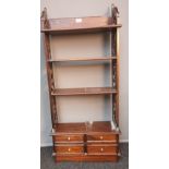 Antique style mahogany unit, four open shelves flanked by pierced and carved sides, above four short