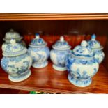 Shelf of Chinese blue and white temple jars.