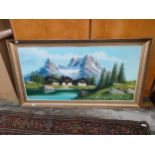 Large oil painting depicting mountain scene with rural buildings to front fitted in a gilt frame