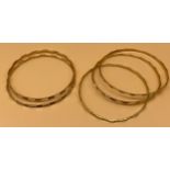 Five 18ct yellow gold bangles. Set of Three and Set of two matching bangles. [38.43grams] [Will