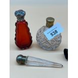 Three antique cut glass perfume bottles. Ruby cut glass and silver lid bottle, cut glass and