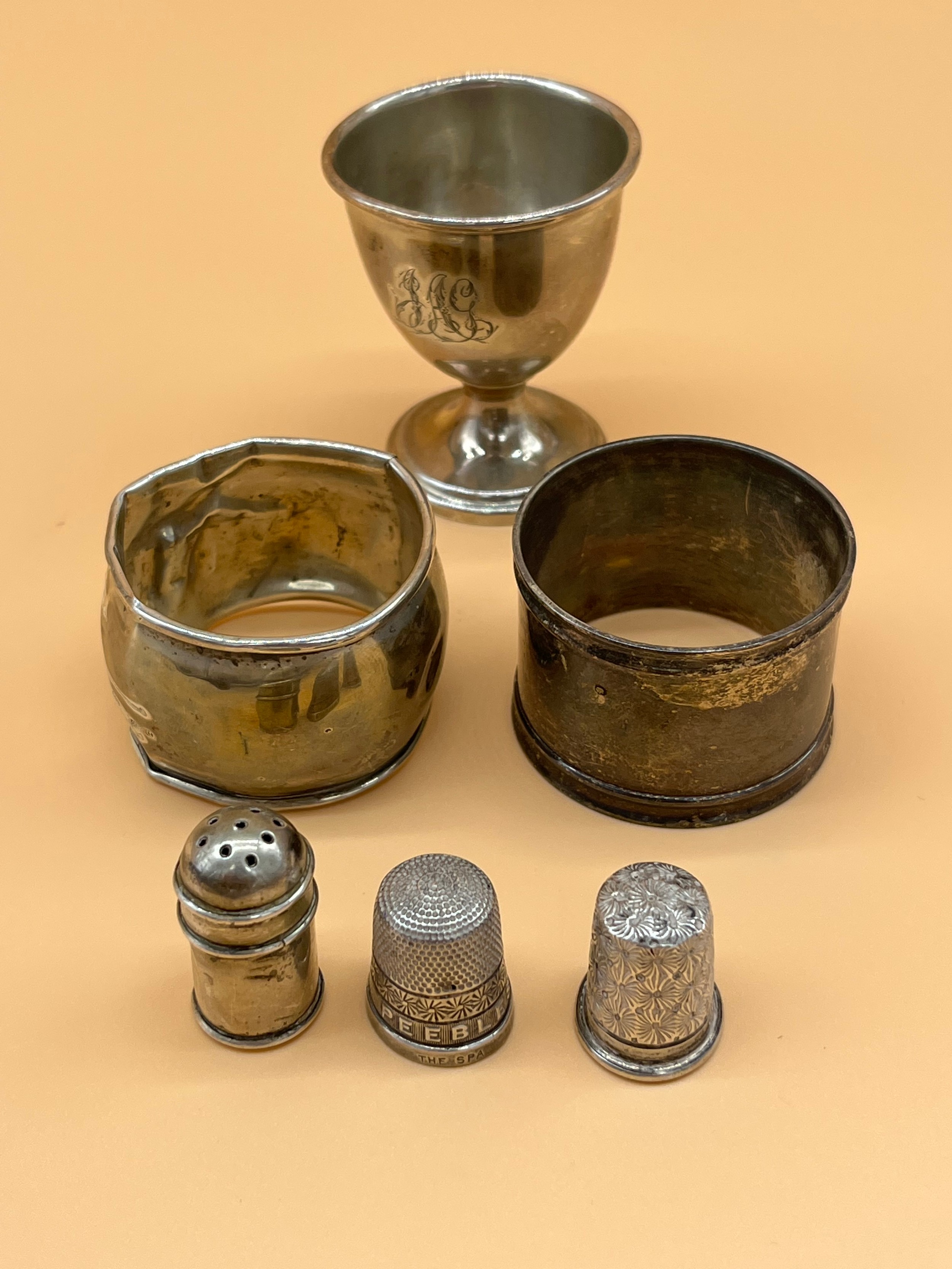 Various silver to include two napkin rings, Egg cup, small pepper pot and two silver thimbles to