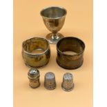 Various silver to include two napkin rings, Egg cup, small pepper pot and two silver thimbles to