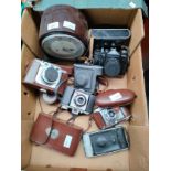 Box of vintage cameras includes zenit and Braun Nurnberg camera together with Bakelite Smiths mantle