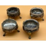 Four 19th century Scottish silver three foot condiment pots, three with glass liners. [218.
