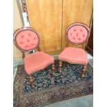 Pair of Victorian button back chairs. Supported on turned legs. [One has signs of old wood worm]