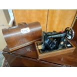Singer sewing machine in fitted wooden case with key .