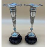 A Pair of Chinese Export silver bud vases sat upon carved wooden stands. [20cm high] Maker's mark to