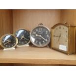 A Lot of three vintage alarm clocks and a mantle clock