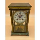 19th century Brass and bevel glass mantel clock, designed with an enamelled face depicting cherub