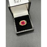 Gold ring set with an emerald cut Ruby. [Stamped S700- Foreign 18ct gold] [8.60grams] [Ring size O]