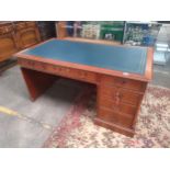 Large Reproduction leather topped knee hole desk. Needs attention together with desk chair.