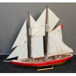 A Large hand built sailing ship fitted with sails and rigging. Comes with wooden stand. [69x79cm]