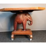 Ashanti elephant table, the octagonal top above a carved elephant, raised on a plinth base ending in