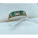 18ct yellow gold diamond and emerald set ring. Set with three round cut diamonds and two emerald cut