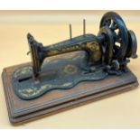 Antique hand crank fiddle base singer sewing machine.
