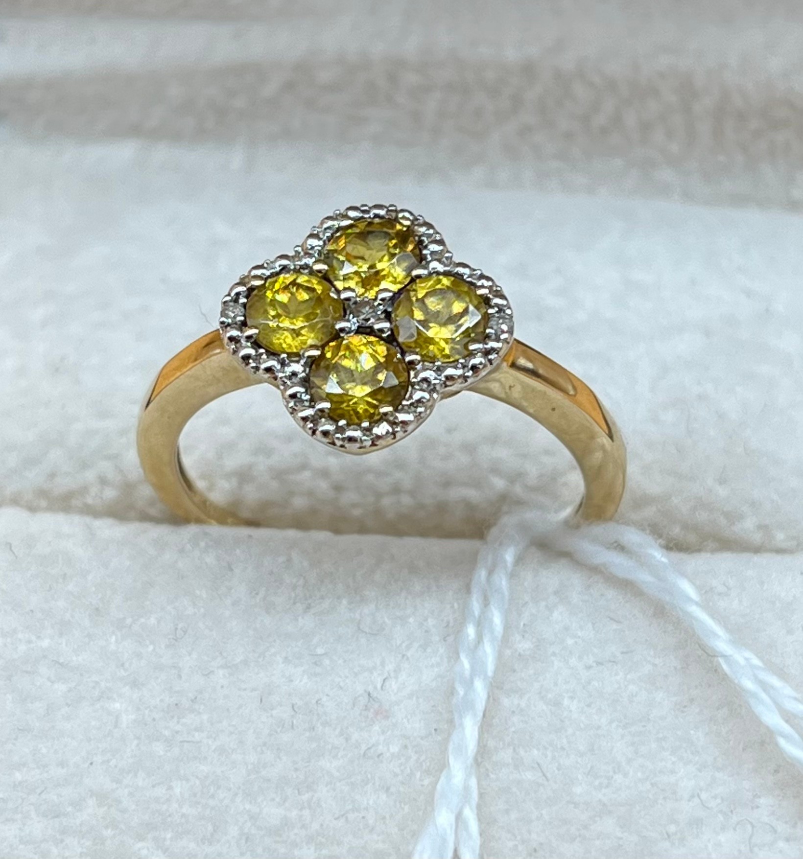 10ct yellow gold ladies ring set with four yellow tourmaline stones surrounded by diamond