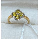 10ct yellow gold ladies ring set with four yellow tourmaline stones surrounded by diamond