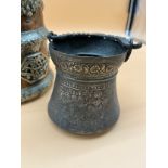 Indian copper and brass worked temple vase, together with metal engraved swing handle urn