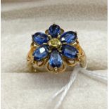 9ct yellow gold ladies ring set with 6 blue topaz stones and single white topaz stone set like a