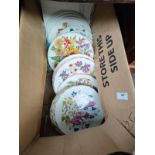 A box of Royal Albert flower pattern collectors plates