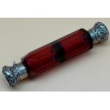 Antique ruby cut glass double end perfume bottle, fitted with silver ornate lids. Stopper